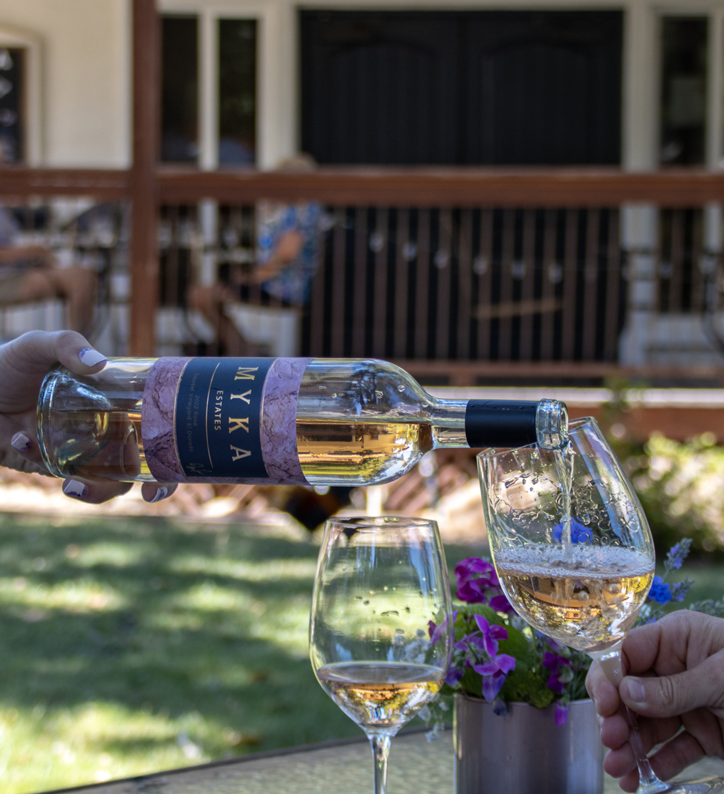 Glass of Rosé being poured into a glass