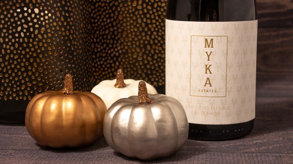 Myka Estates Cotes du Cruz Rouge wine bottle with pumpkins and candles