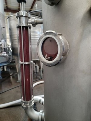 Newly pressed wine in tank at the winery 