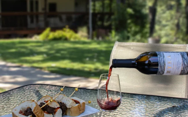 Pouring a glass of Myka Estates wine to enjoy with food