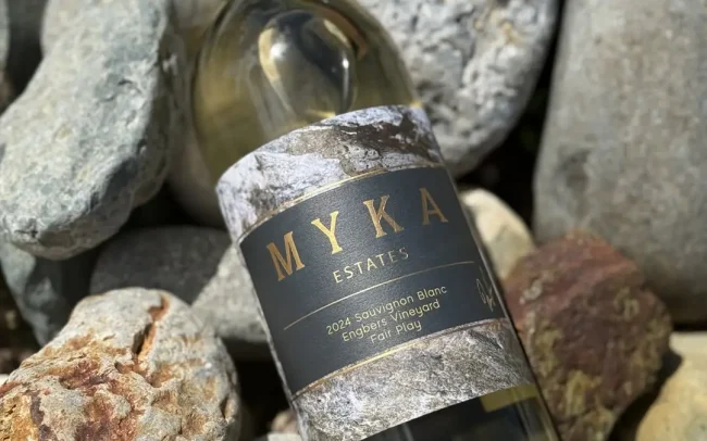 Bottle of Myka Estates 2024 Sauvignon Blanc on a rock pile